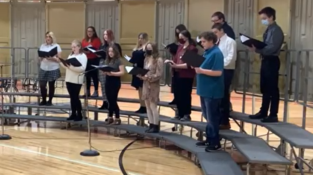 Image of 8th grade choir students on a riser during concert