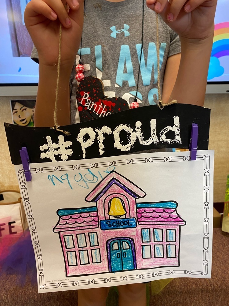 A student holding their Panther Proud sign.