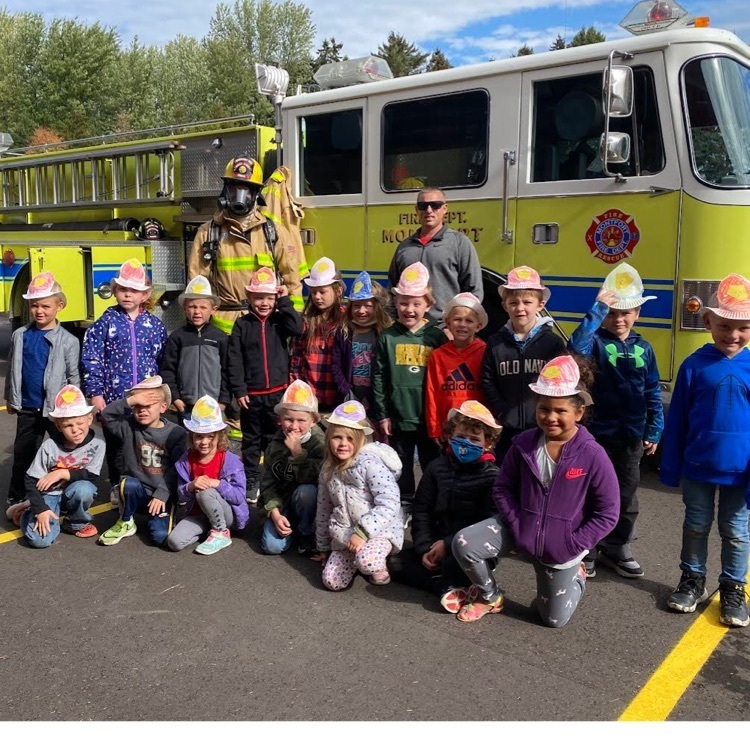 students in front of fire truck  