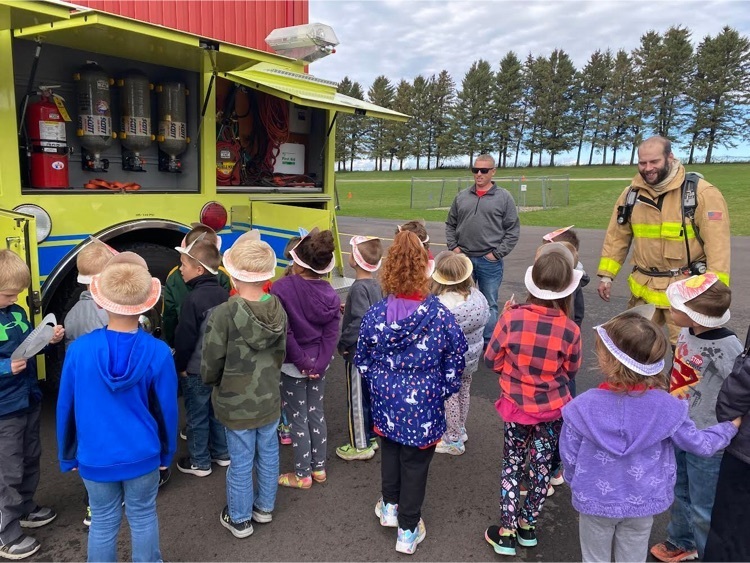 Students look at equipment in firetruck.  