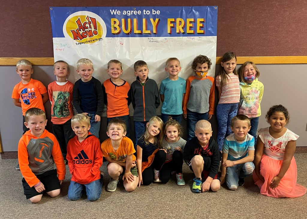Picture of the "Fireflies" in front of a We agree to Bully Free sign.