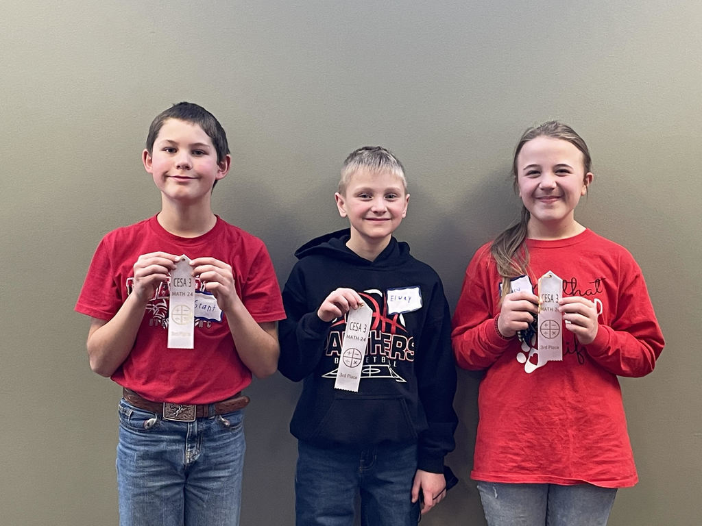 3 students holding their math ribbon