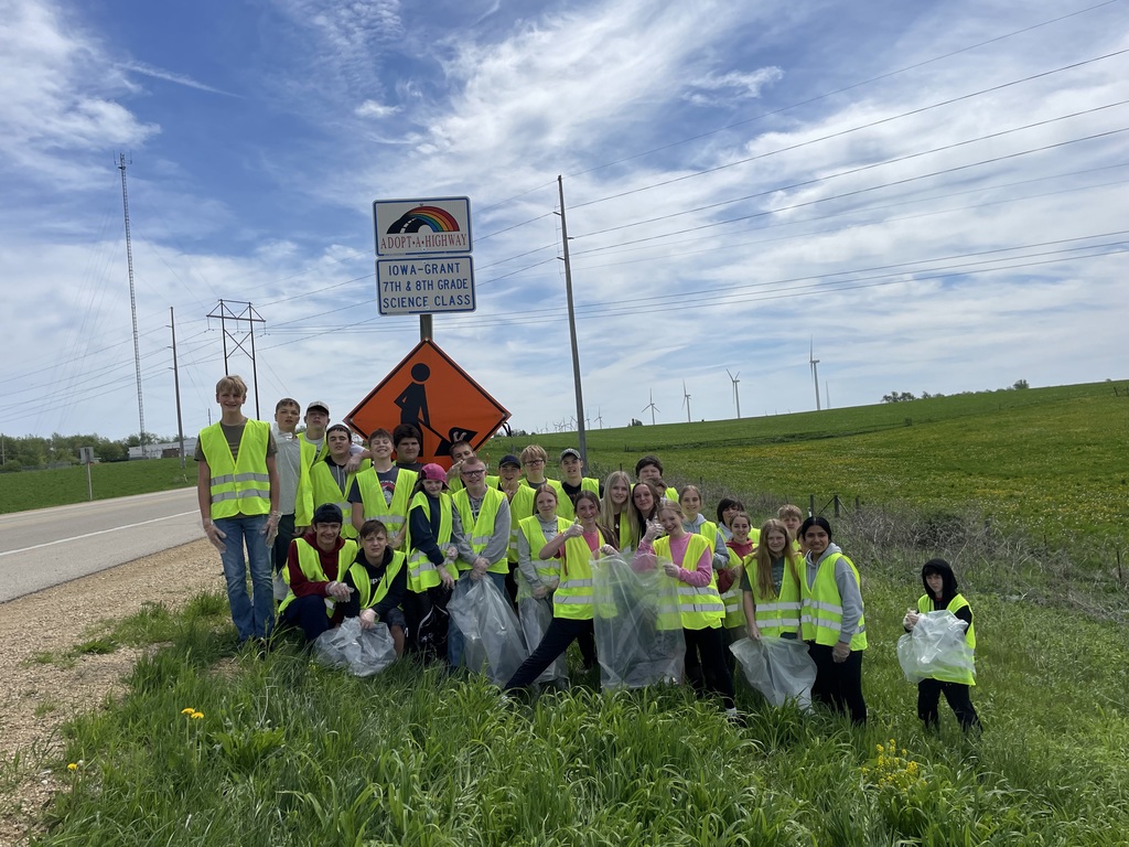 8th graders in front of sign when picking up trash for adopt a highway.
